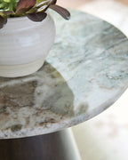 Round accent table top with gray, white, and brown stone-like surface texture