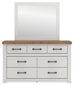 White dresser with wood top and six drawers with dark bar handles