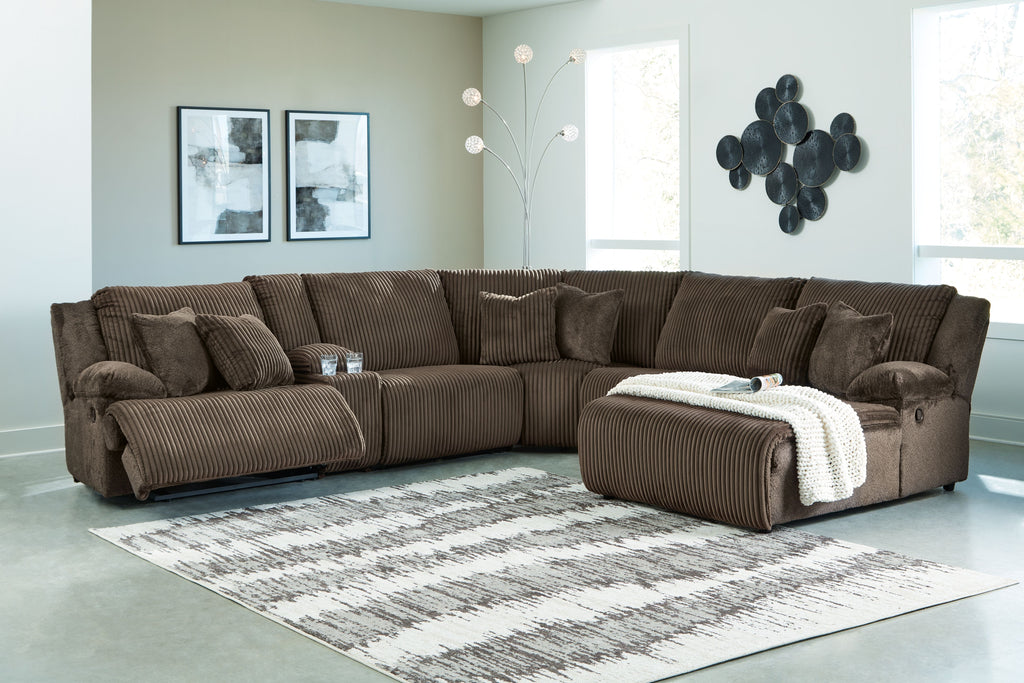 Brown ribbed reclining sectional sofa with chaise and cushioned back pillows