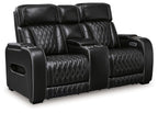 Black power reclining loveseat with console, diamond-quilted upholstery, and padded headrests