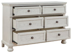 Antique white dresser with seven drawers and round knob pulls, open drawer fronts.