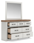White dresser with wood top, open drawers, dark bar pulls