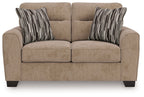 Light brown upholstered loveseat with two seat cushions and striped throw pillows