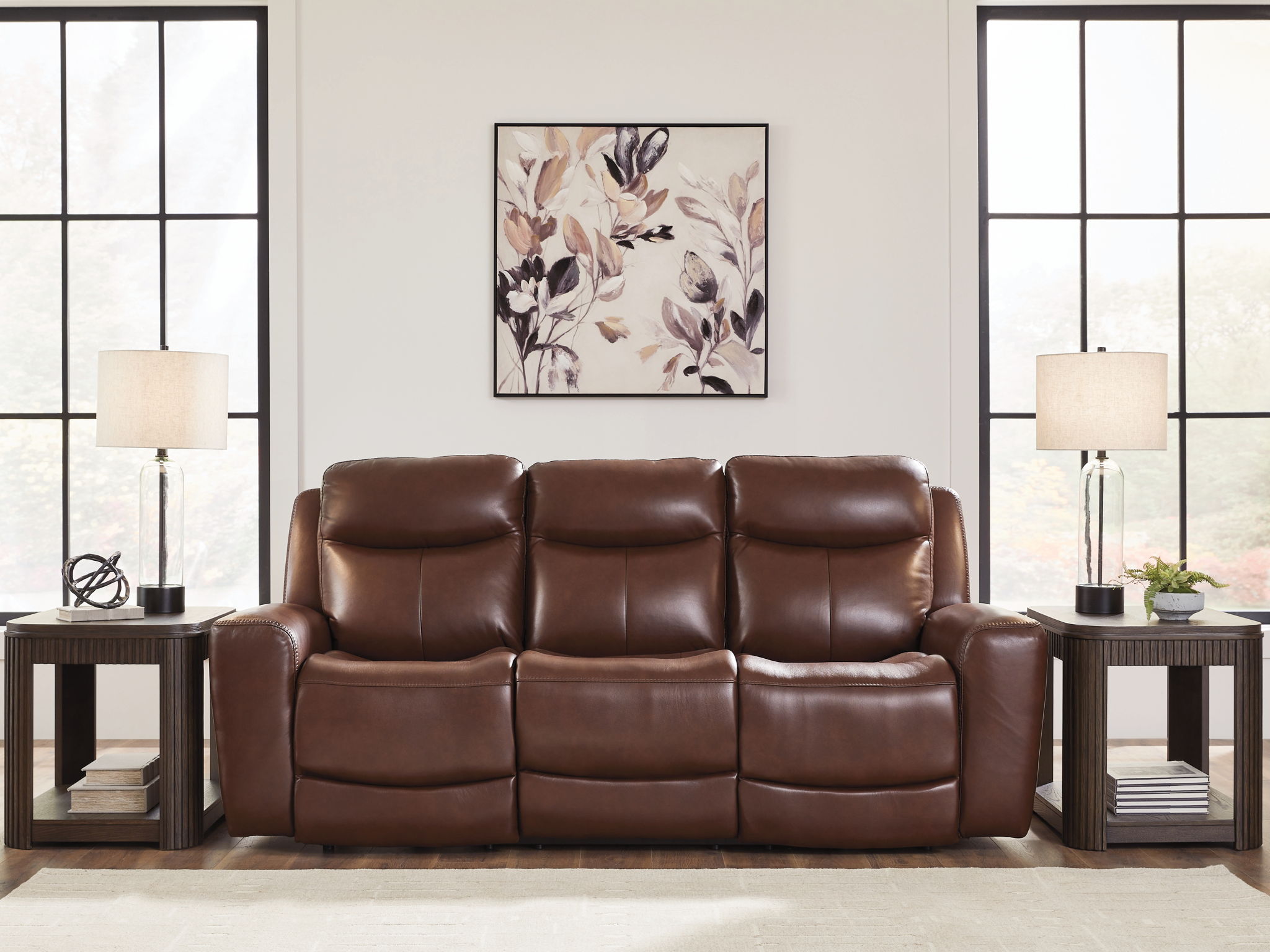 Dark brown power reclining sofa with three padded seats and adjustable headrests