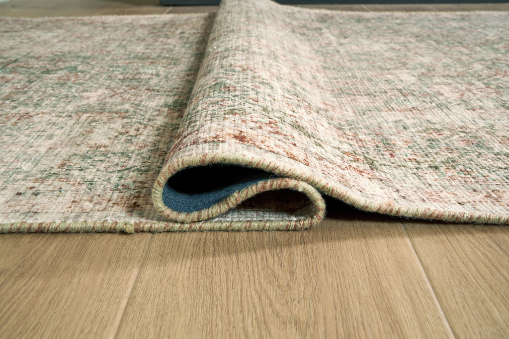 Rossbury rug rolled edge detail, light speckled fibers with short fringed trim