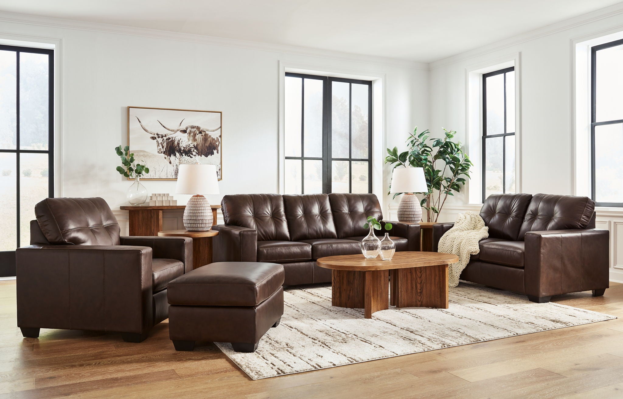 Dark brown upholstered living room set with sofa, armchairs, and ottoman poufs