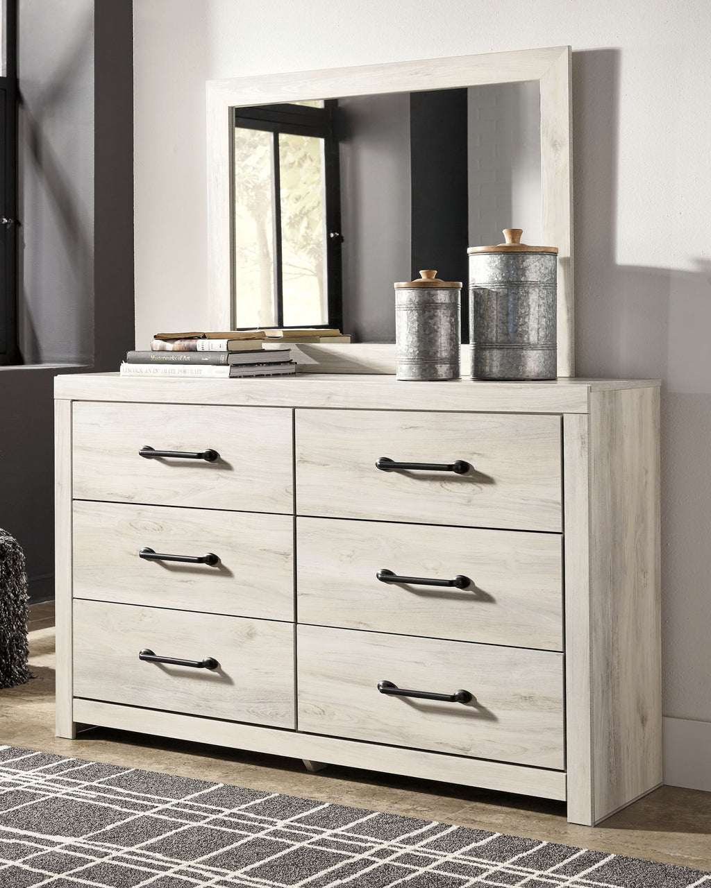 Beige dresser with mirror, six drawers and black bar handles