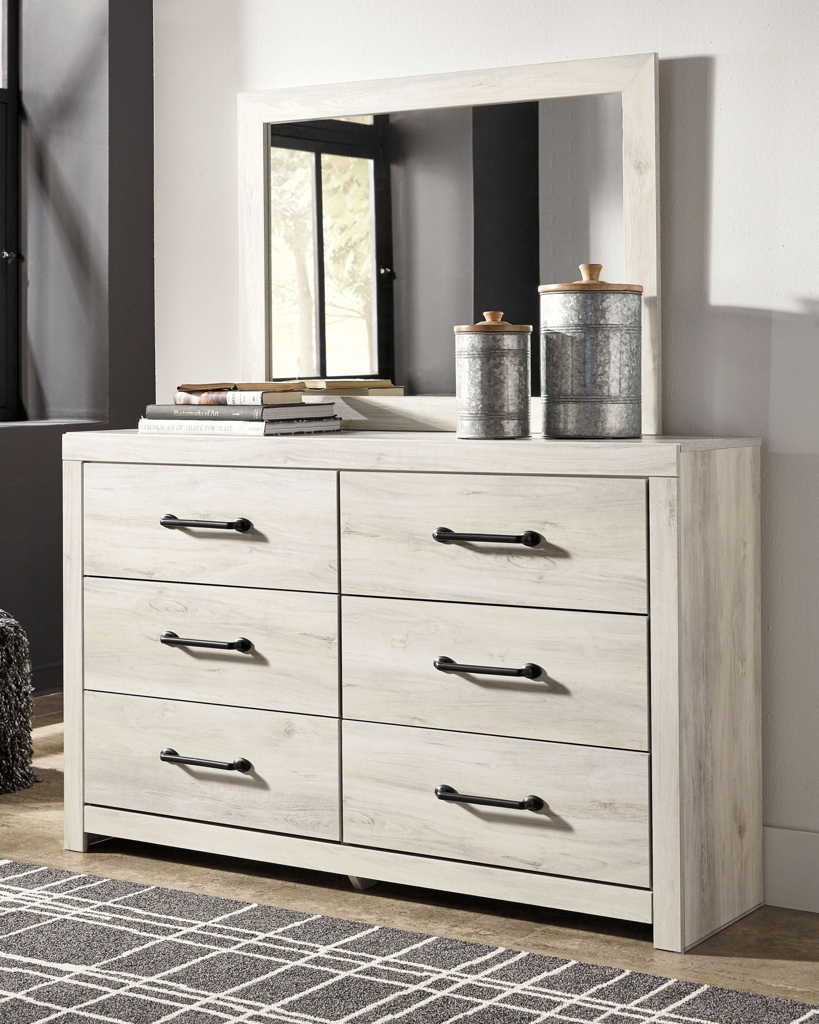 Beige dresser with mirror, six drawers and black bar handles