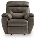 Dark gray rocker recliner with rounded back and cushioned seat, front view