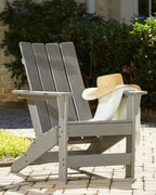 Gray Adirondack chair with slatted back and arms, outdoor patio view