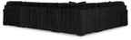 Black sectional sofa with ribbed upholstery and clean backrest cushion