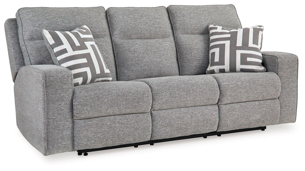 Pewter power reclining sofa in gray fabric with wide arms, patterned throw pillows, and headrests