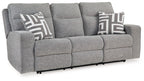 Pewter power reclining sofa in gray fabric with wide arms, patterned throw pillows, and headrests