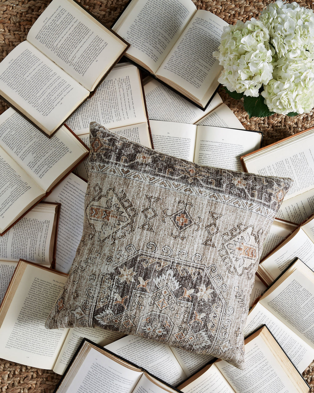 Decorative pillow with gray geometric design and small orange accents