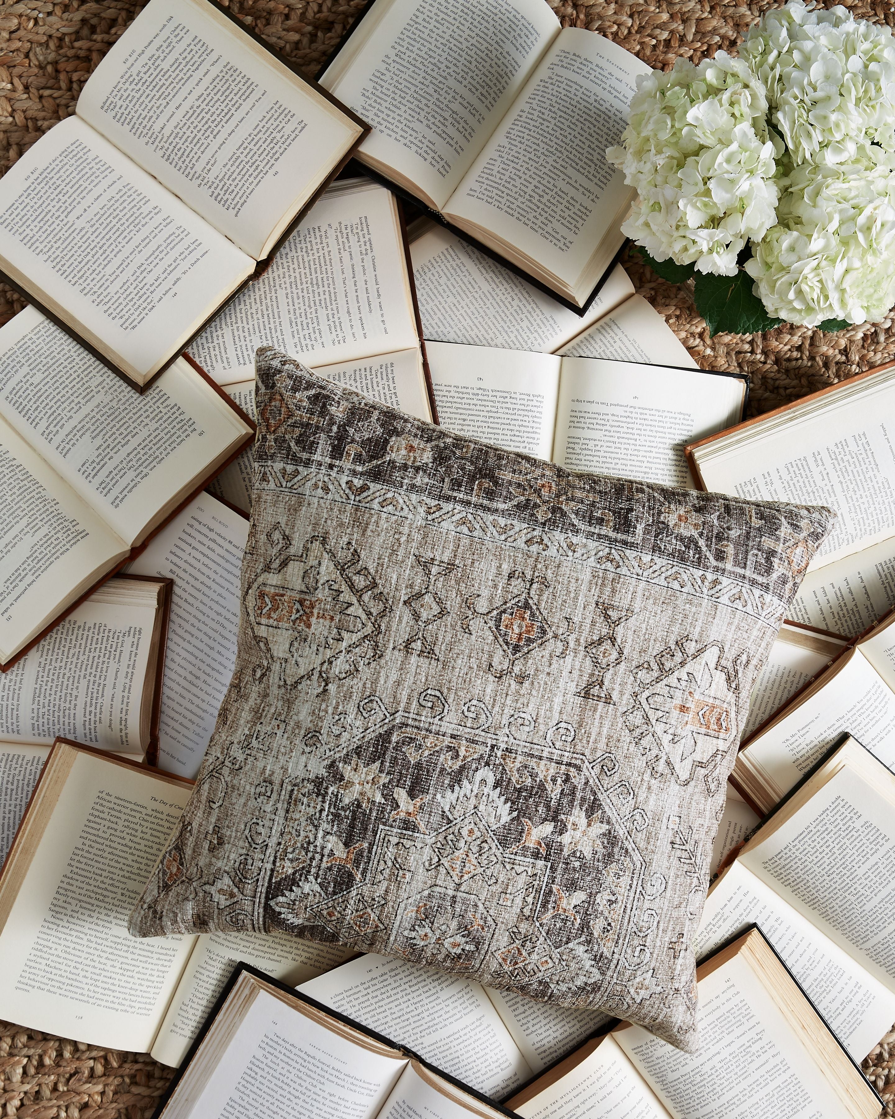 Decorative pillow with gray geometric design and small orange accents