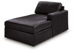 Black corner chaise with low armrest and wide seat, shown from side angle