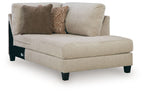 Latte corner chaise sofa with beige upholstery, dark legs, and two throw pillows