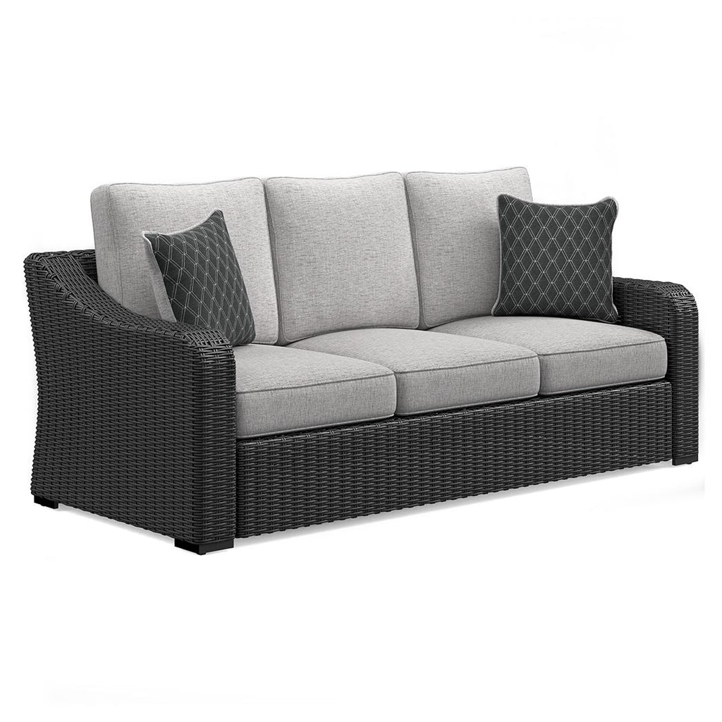 Beachcroft sofa with cushions: dark wicker frame, light gray cushions, diamond pillows