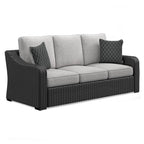 Beachcroft sofa with cushions: dark wicker frame, light gray cushions, diamond pillows