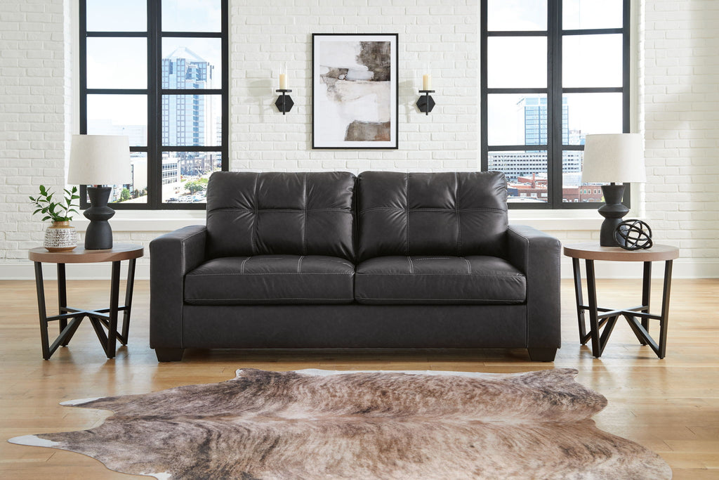Dark leather-look loveseat with two seat cushions and tufted backrest, straight arms