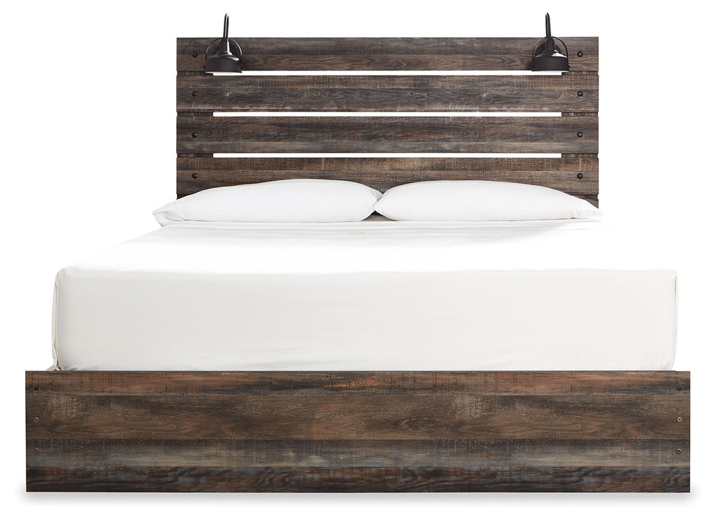 Panel bed with slatted headboard and dark wood front rail, white pillows and mattress