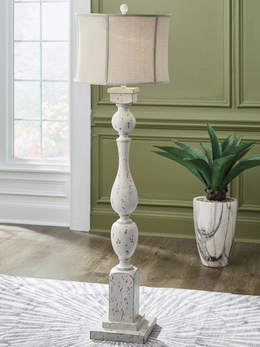 White drum-shade lamp with distressed speckled base and tapered turned details
