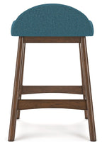 Upholstered barstool with teal blue fabric seat and curved back, visible wood frame.