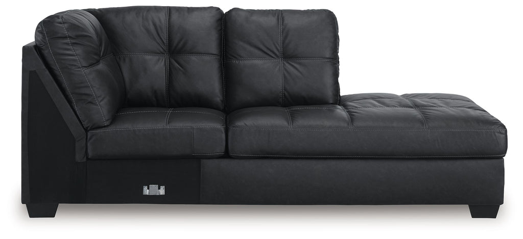 Dark charcoal corner chaise with tufted back, padded arms, and low block legs