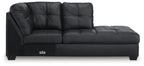 Dark charcoal corner chaise with tufted back, padded arms, and low block legs