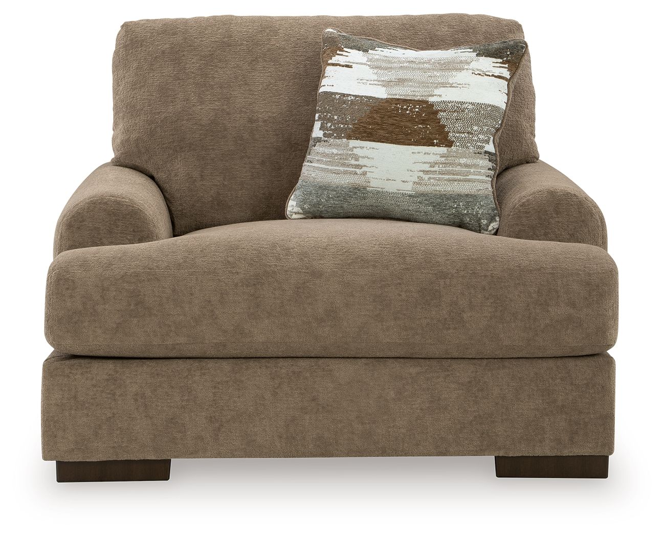Armchair in light brown fabric with deep seat, broad arms, and one patterned throw pillow