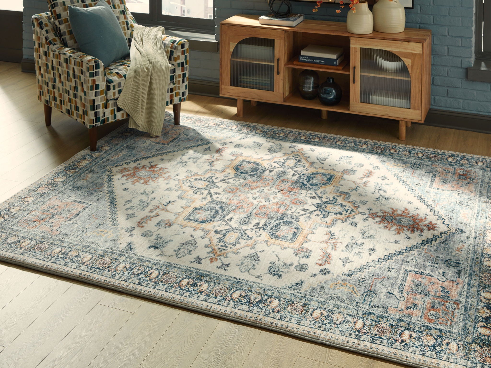 Wallney rug flat with central medallion, blue-gray tones, cream ornamental border