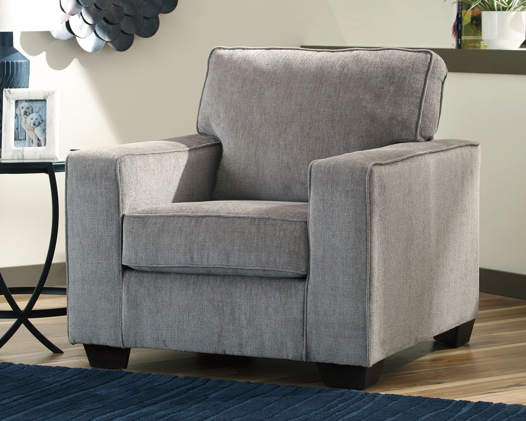 Light gray upholstered arm chair with tall backrest, padded arms, and tuft-free seat
