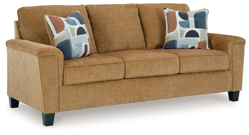 Beige sofa with three seat cushions and patterned throw pillows