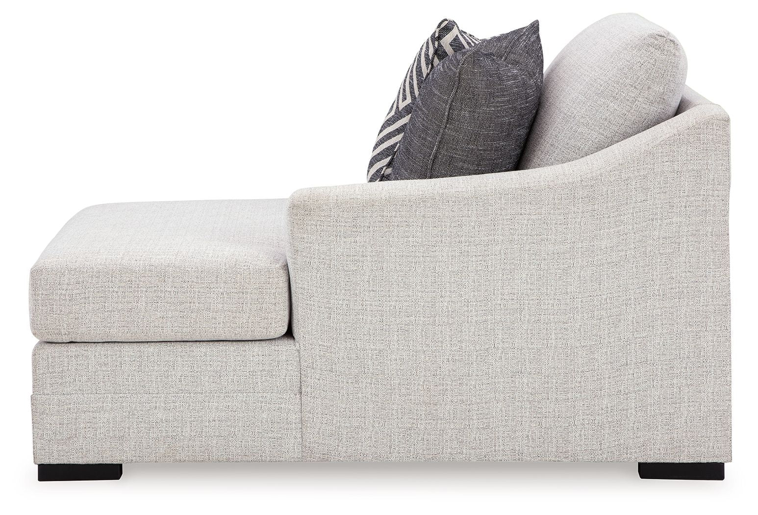 Light gray corner chaise with wide armrest and dark geometric throw pillow.
