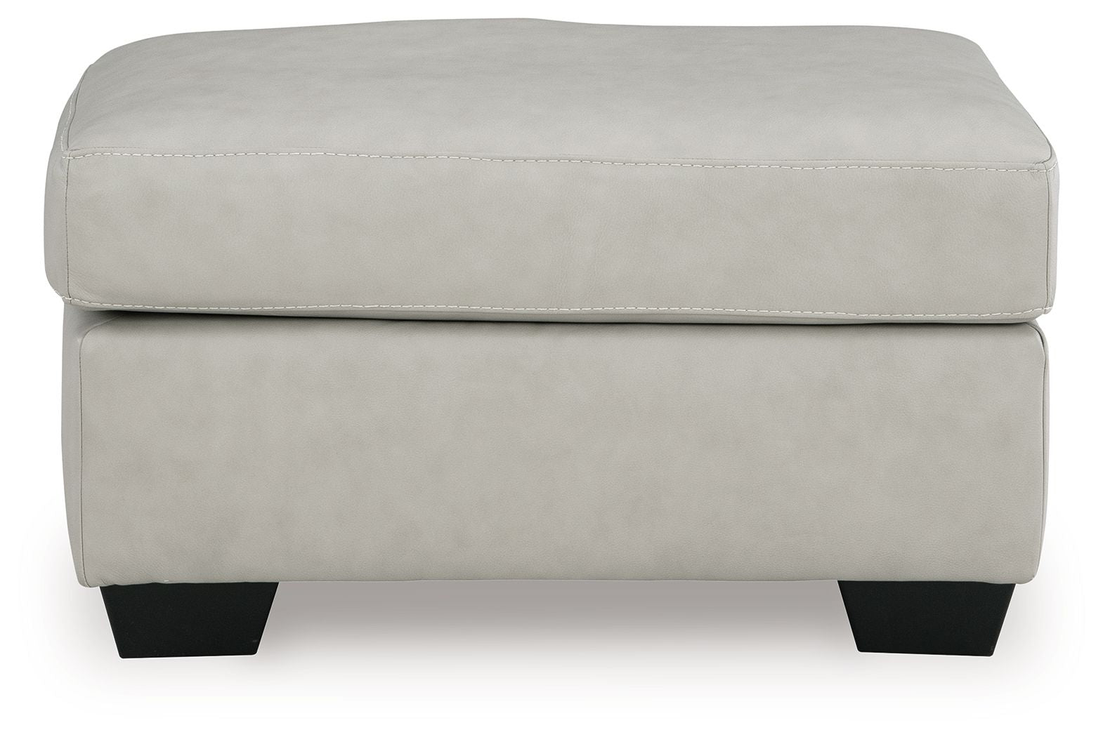 Light beige ottoman with padded top, smooth upholstery, and dark block legs