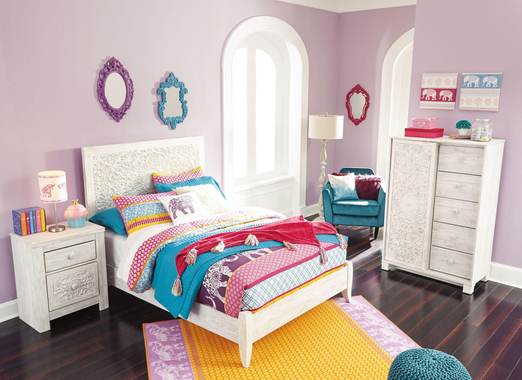 White youth panel headboard with carved floral pattern, centered on the bed