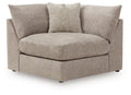 Upholstered wedge sofa with beige burlap-style throw pillow, light gray seat