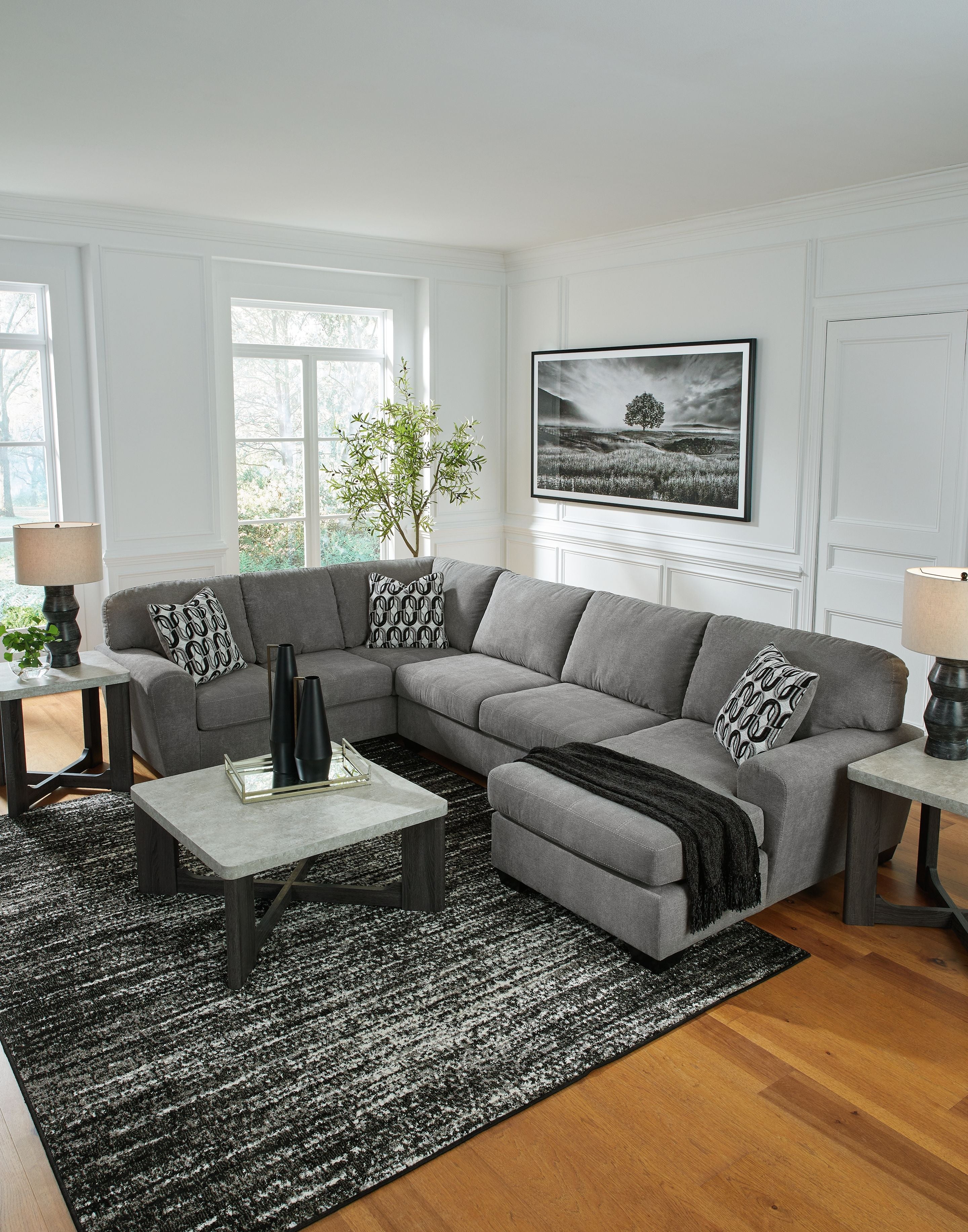 Gray sectional sofa with chaise and patterned pillows, wide seat cushions