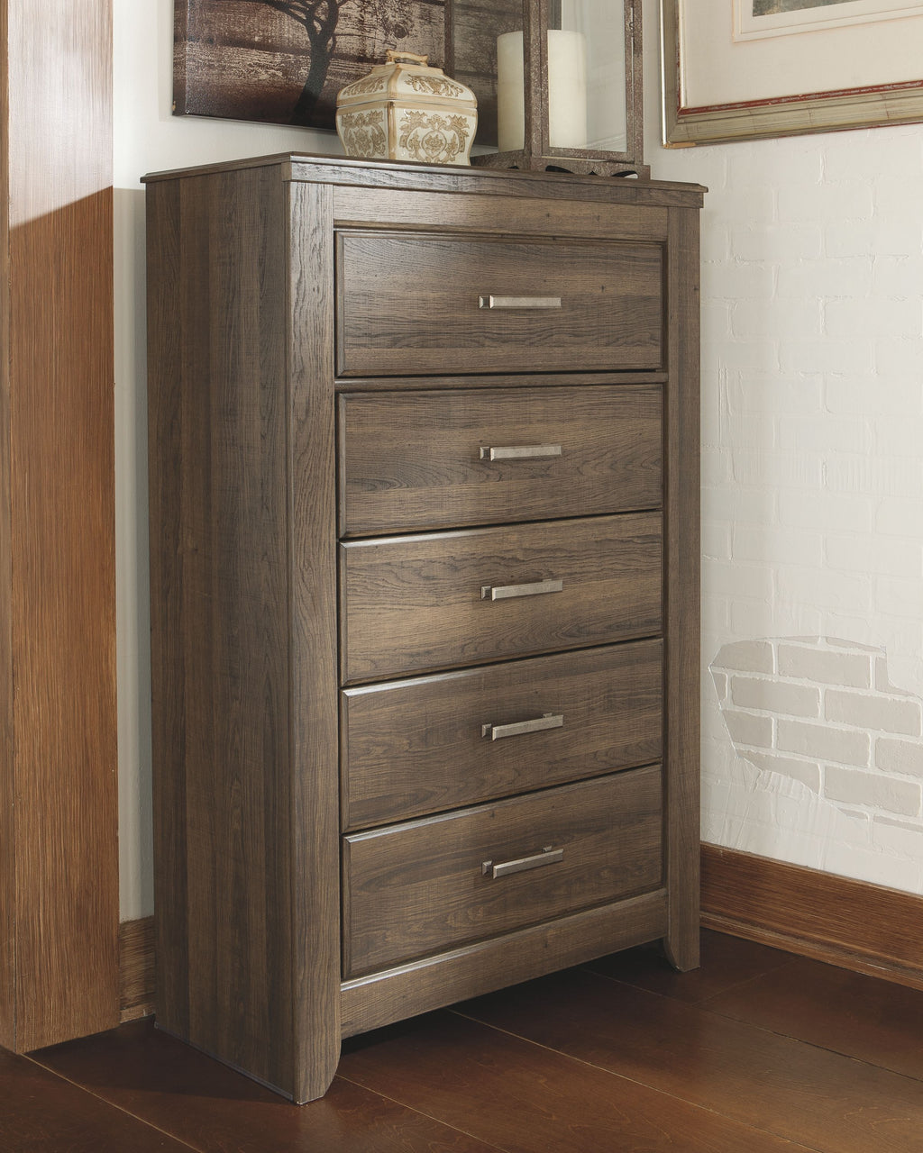 Juararo five-drawer chest in dark brown, front corner view with silver handles
