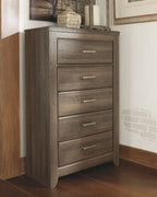 Juararo five-drawer chest in dark brown, front corner view with silver handles