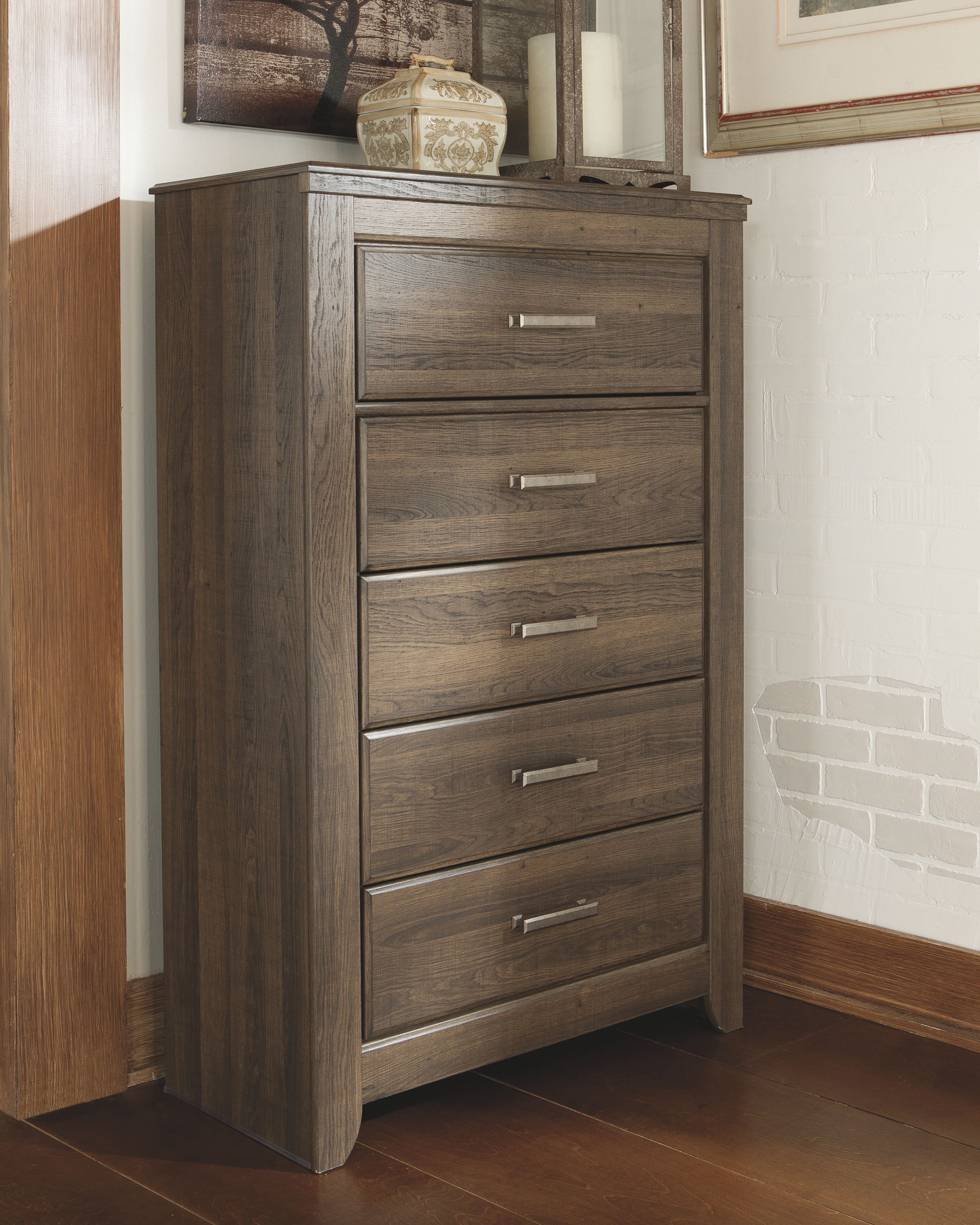 Juararo five-drawer chest in dark brown, front corner view with silver handles