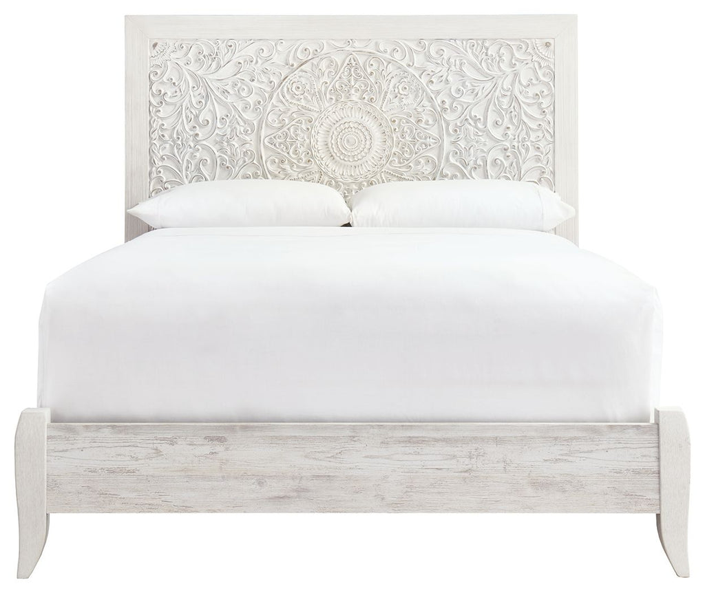 Whitewash queen panel headboard with ornate white fabric backing and upholstered bed