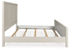 White panel bed frame with center support slats and open underside, headboard visible