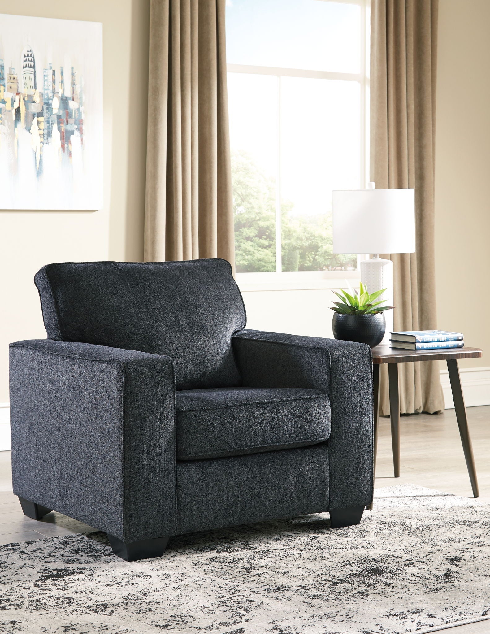 Dark gray fabric arm chair with tall back, thick padded arms, and square base