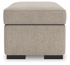 Heather fabric ottoman with rounded top and visible black feet