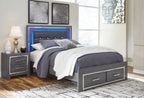 Gray upholstered panel bed with button-tufted headboard and two drawers