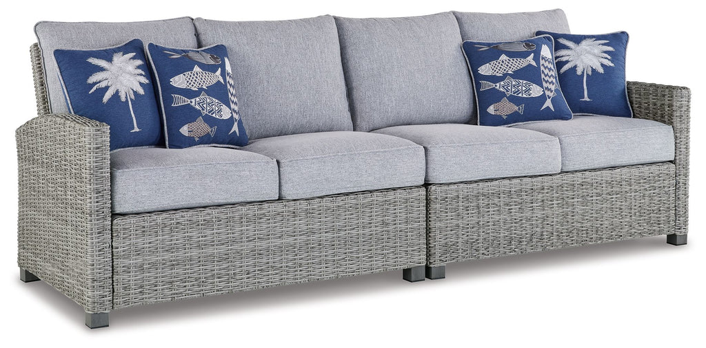 Light gray 3-seat outdoor sofa with blue patterned throw pillows