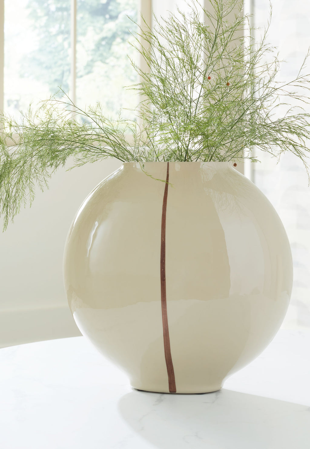Beige ceramic vase with glossy surface and vertical brown stripe, bulbous shape