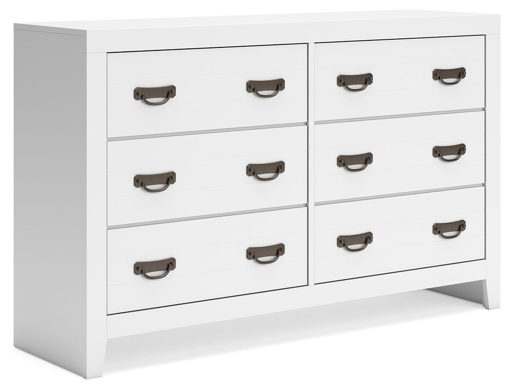 White dresser with multiple drawers and dark metal pull handles