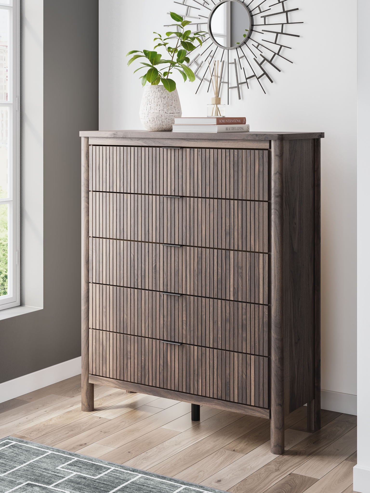 Brown five-drawer wide chest with four drawer fronts outlined by dark horizontal lines